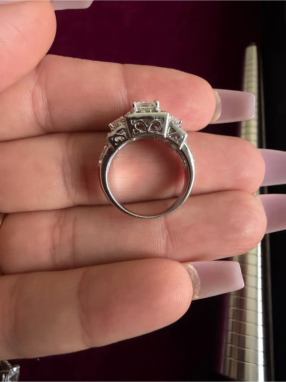 Clear 3 square stones with clusters ring and side stones. Size 7